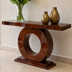 Amber mahogany-finish server table with a single ring base and moulded plinth, styled with a glass vase and bronze vases