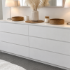 Drift matte white handle-free 6-drawer chest of drawers, styled with lamps, baskets and a pampas vase
