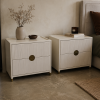 Pair of Halo pedestals shown beside a bed, showing the fluted drawer fronts and brass pulls