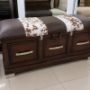 Ikhaya Bench in a showroom setting, three drawers and cowhide-striped seat