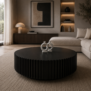 Reed fluted drum coffee table shown in a living room in front of a sectional sofa