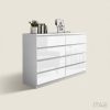 Sheen high-gloss white 8-drawer chest of drawers, handle-free, styled with books, a plant and a framed print