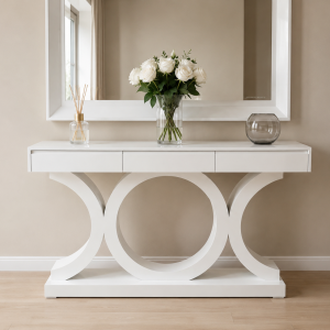 Trove gloss white server table with three ring legs and three integrated drawers, styled beneath a mirror with a diffuser and roses — Itae Furniture